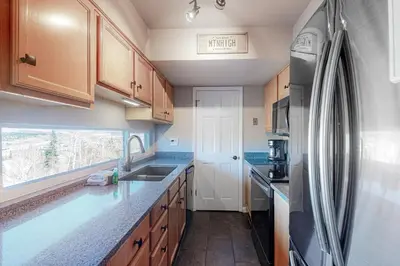 a kitchen with a sink and a refrigerator at Wildernest Rest in Silverthorne