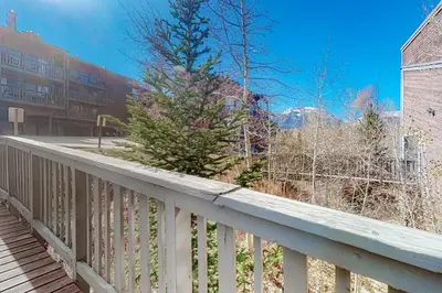 a white railing with a christmas tree on it at Wildernest Rest in Silverthorne