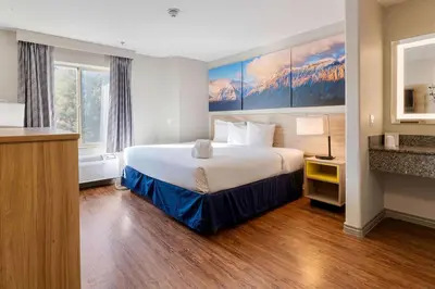 a hotel room with a large bed and a desk at Days Inn by Wyndham Thornton in Thornton