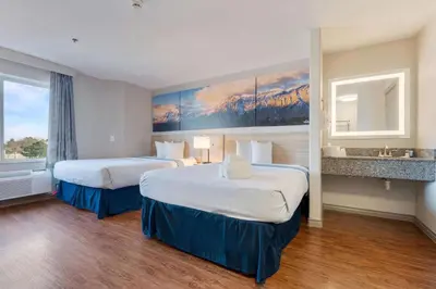 a hotel room with two beds and a large window at Days Inn by Wyndham Thornton in Thornton