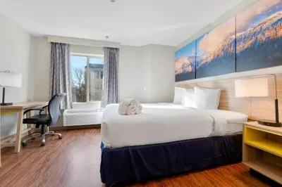 a hotel room with a bed and a desk at Days Inn by Wyndham Thornton in Thornton