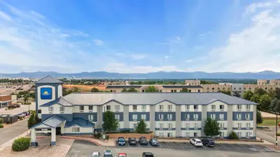 an aerial view of a building with a parking lot at Days Inn by Wyndham Thornton in Thornton