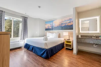 a hotel room with a bed and a sink at Days Inn by Wyndham Thornton in Thornton