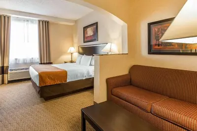 a hotel room with a bed and a couch at Comfort Suites Summit County in Dillon