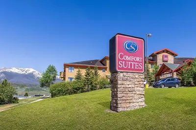 a sign for a car dealership in front of a house at Comfort Suites Summit County in Dillon