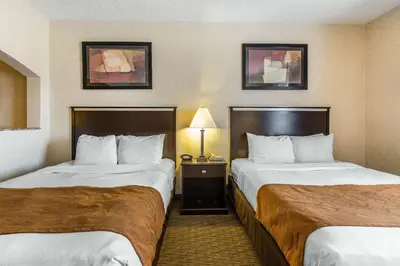 a hotel room with two beds and a lamp at Comfort Suites Summit County in Dillon