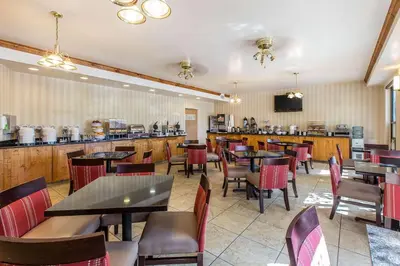 a restaurant with tables and chairs and a bar at Comfort Suites Summit County in Dillon
