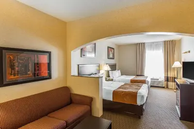 a hotel room with two beds and a couch at Comfort Suites Summit County in Dillon