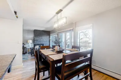 a kitchen and dining room with a table and chairs at Mountain Meadows 302 in Frisco