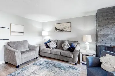 a living room with a couch and a chair at Mountain Meadows 302 in Frisco