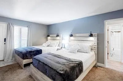 two beds in a bedroom with blue walls at Mountain Meadows 302 in Frisco