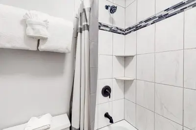 a bathroom with a shower and a toilet and towels at Mountain Meadows 302 in Frisco