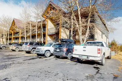 a parking lot with cars parked in front of a building at Mountain Meadows 302 in Frisco