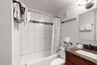 a bathroom with a tub and a toilet and a sink at Mountain Meadows 302 in Frisco
