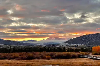 a sunset in the mountains with a train in a field at Mountain Meadows 302 in Frisco