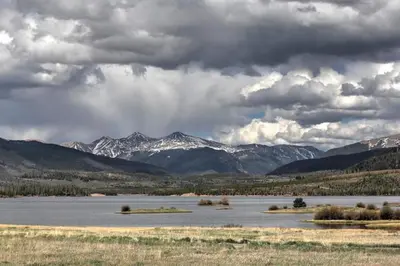 a large body of water with mountains in the background at Mountain Meadows 302 in Frisco