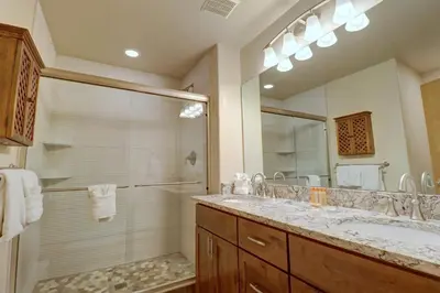 a bathroom with a shower and a sink and a mirror at Prospector Point E 4Br 3,5Ba townhouse in Frisco