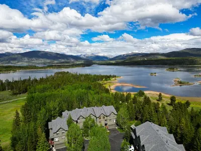 an aerial view of a house next to a lake at Prospector Point E 4Br 3,5Ba townhouse in Frisco