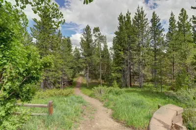 a dirt road through a field with trees at Prospector Point E 4Br 3,5Ba townhouse in Frisco