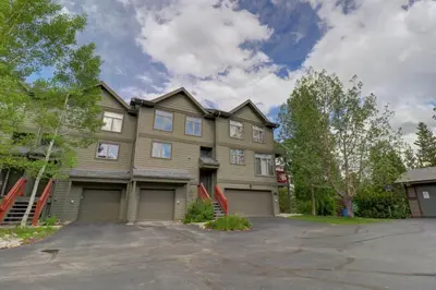 a large house with a driveway in front of it at Prospector Point E 4Br 3,5Ba townhouse in Frisco