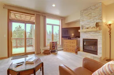 a living room with a fireplace and a couch at Prospector Point E 4Br 3,5Ba townhouse in Frisco