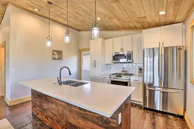 a kitchen with a sink and a refrigerator at Balconies and Idyllic Views Grand Lake Haven! in Grand Lake