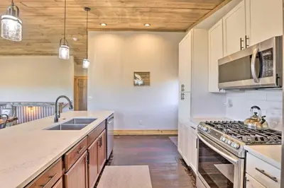 a kitchen with a sink and a stove top oven at Balconies and Idyllic Views Grand Lake Haven! in Grand Lake