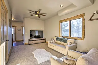 a living room with two couches and a flat screen tv at Balconies and Idyllic Views Grand Lake Haven! in Grand Lake