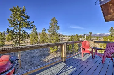 a deck with two chairs and a table at Balconies and Idyllic Views Grand Lake Haven! in Grand Lake