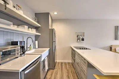 a kitchen with a stainless steel refrigerator and sink at Walk to Main St Frisco! Modern Unit 7 Mi to Slopes in Frisco