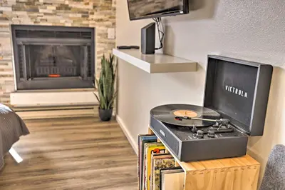 a living room with a stove and a fireplace at Walk to Main St Frisco! Modern Unit 7 Mi to Slopes in Frisco
