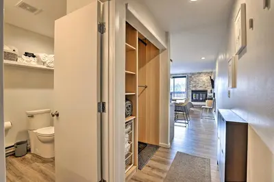 a bathroom with a toilet and a hallway at Walk to Main St Frisco! Modern Unit 7 Mi to Slopes in Frisco