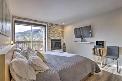 a bedroom with a large bed with a fireplace at Walk to Main St Frisco! Modern Unit 7 Mi to Slopes in Frisco