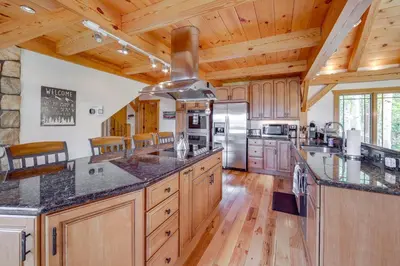 a large kitchen with wooden floors and wooden ceilings at 7 Mi to Rocky Mtn Natl Park Grand Lake Home! in Grand Lake