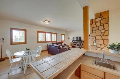 a kitchen and living room with a table and a couch at 7 Mi to Rocky Mtn Natl Park Grand Lake Home! in Grand Lake