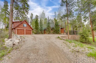 a dirt road leading to a cabin in the woods at 7 Mi to Rocky Mtn Natl Park Grand Lake Home! in Grand Lake