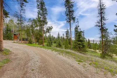 a dirt road in the middle of a forest at 7 Mi to Rocky Mtn Natl Park Grand Lake Home! in Grand Lake