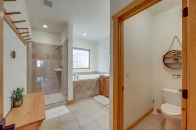 a bathroom with a shower and a toilet and a tub at 7 Mi to Rocky Mtn Natl Park Grand Lake Home! in Grand Lake