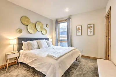 a bedroom with a large bed and a window at 13 Mi to Slopes! Silverthorne Home with Pool Access in Silverthorne