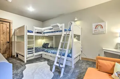 a bedroom with two bunk beds and a ladder at 13 Mi to Slopes! Silverthorne Home with Pool Access in Silverthorne