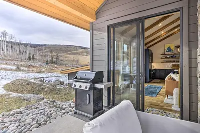 a screened in porch with a grill in a house at 13 Mi to Slopes! Silverthorne Home with Pool Access in Silverthorne