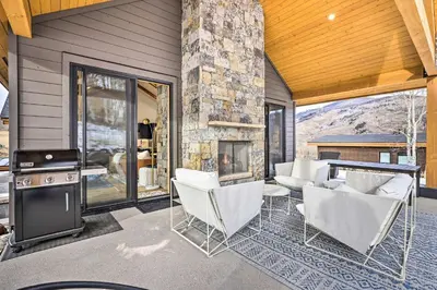a living room with chairs and a fireplace at 13 Mi to Slopes! Silverthorne Home with Pool Access in Silverthorne