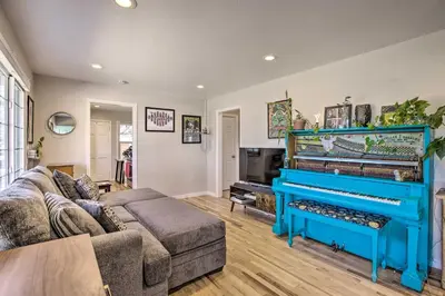 a living room with a couch and a piano at Centrally Located Aurora Home with Covered Patio in Aurora