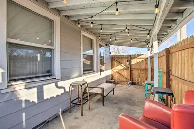 a patio with chairs and lights on a house at Centrally Located Aurora Home with Covered Patio in Aurora