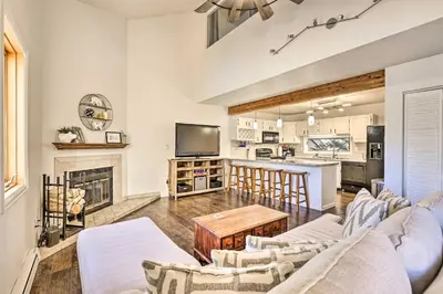 a living room with a couch and a table at Hot Tub and Mtn Views Silverthorne Escape! in Silverthorne
