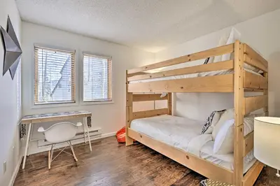 a bedroom with a bunk bed and a desk at Hot Tub and Mtn Views Silverthorne Escape! in Silverthorne