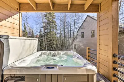 a jacuzzi tub on the deck of a cabin at Hot Tub and Mtn Views Silverthorne Escape! in Silverthorne