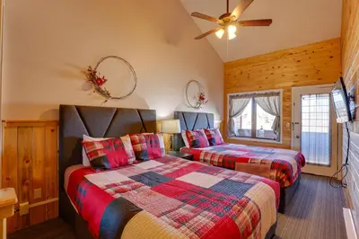 a bedroom with two beds and a ceiling fan at 2 Mi to Granby Ranch Resort Studio with Pool Access in Granby