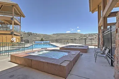 a patio with a pool and a table and chairs at 2 Mi to Granby Ranch Resort Studio with Pool Access in Granby