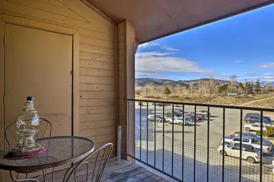 a balcony with a table and a view of a parking lot at 2 Mi to Skiing Studio with Pool Access in Granby! in Granby